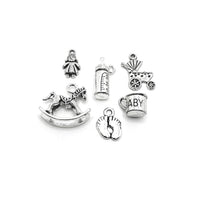 Thirty antique silver baby shower charms of six different designs displayed together on a white background.