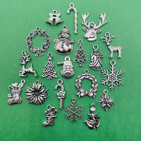 A collection of silver-toned Christmas charms—60 pieces total, featuring 20 unique designs.