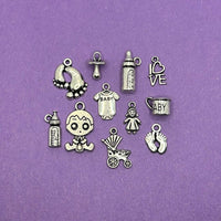 A collection of six distinct silver-toned baby-themed charms (approximately 200 pieces in total) arranged together.