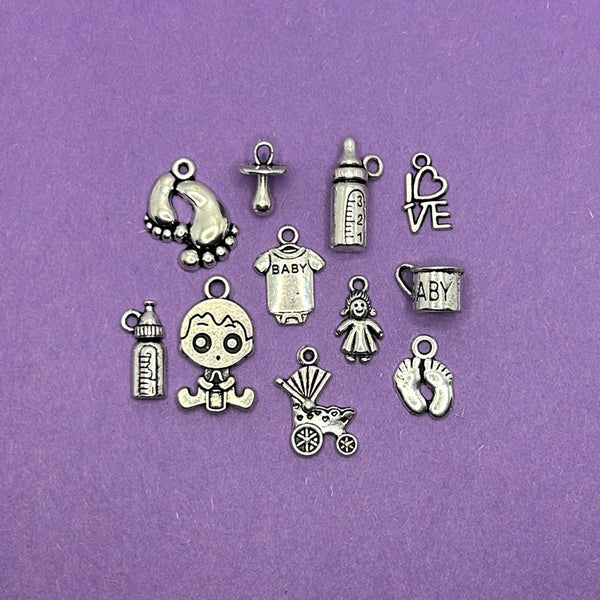 A collection of six distinct silver-toned baby-themed charms (approximately 200 pieces in total) arranged together.