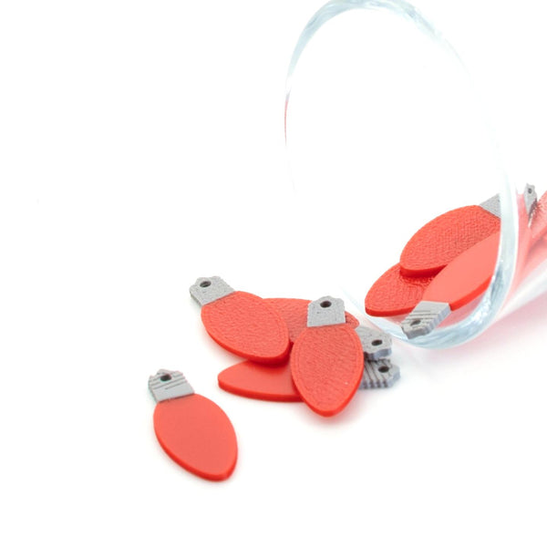 Red miniature Christmas light-bulb charm, approx. 10 × 25 mm, with a loop for hanging, shown on a white background.