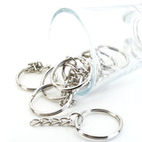 Silver keychains with chain designs on a white background