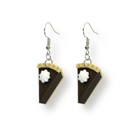 Pair of dangle earrings featuring miniature chocolate pie slice charms with whipped cream topping, attached to 20 × 18 mm ear wires, displayed on a white background.