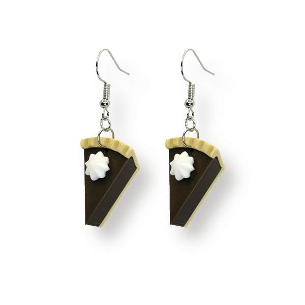 Pair of dangle earrings featuring miniature chocolate pie slice charms with whipped cream topping, attached to 20 × 18 mm ear wires, displayed on a white background.